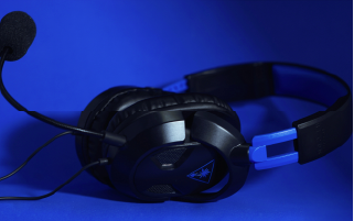 black headphones with microphone on blue background, used for in person, remote and hybrid interpreting solutions.