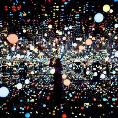 Immersive light installation with vibrant orbs of various colors in a mirrored room, symbolizing skills acquired and brain areas activated through the stages of learning