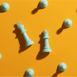 King and Queen chess pieces surrounded by pawns on a yellow background for strategic leadership training