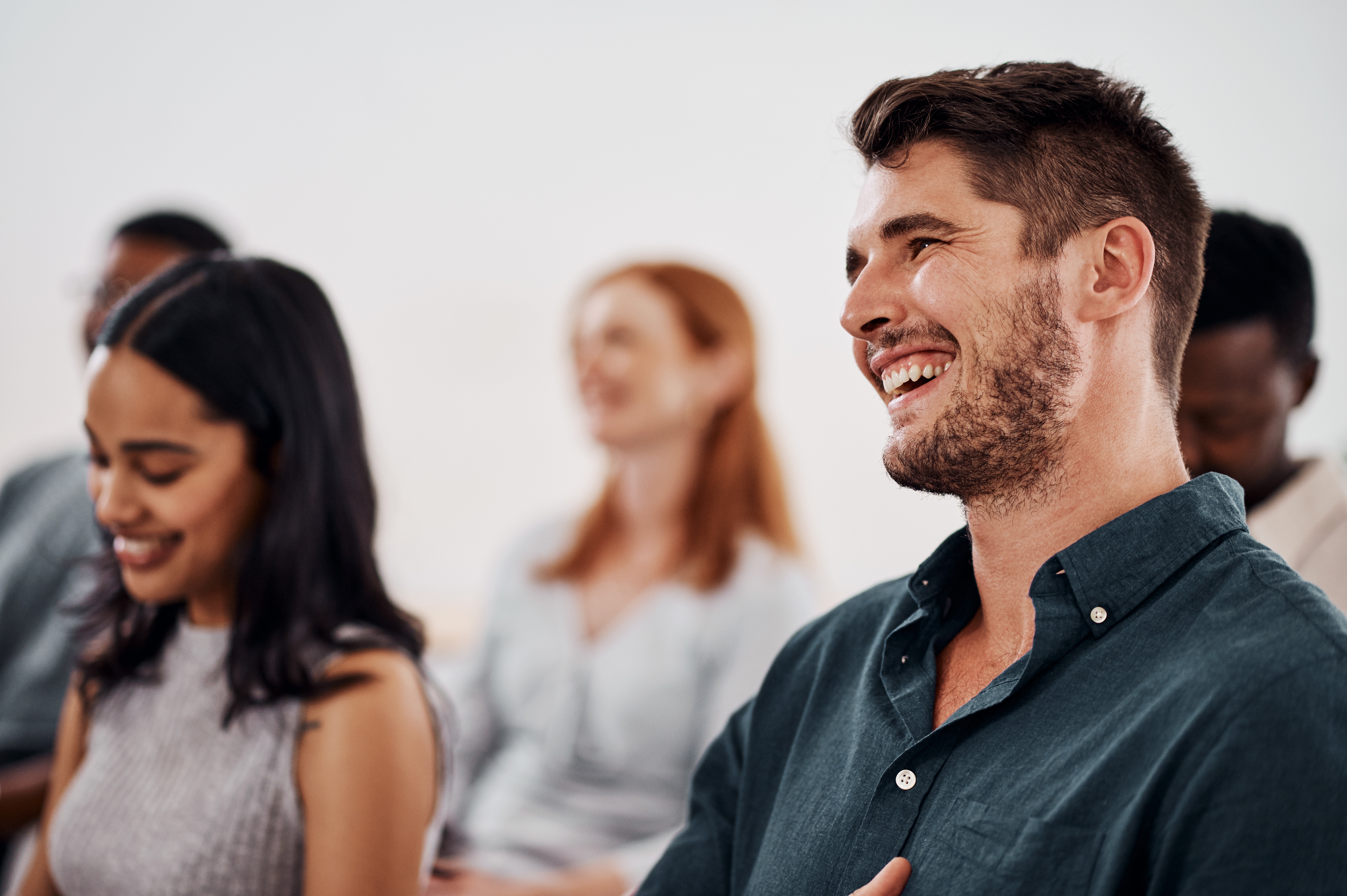 Group of happy young employees in a group Business English course in-person